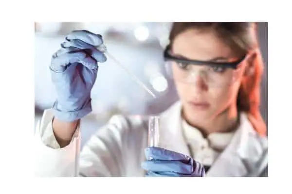 female scientist holding a test tube and a pipette