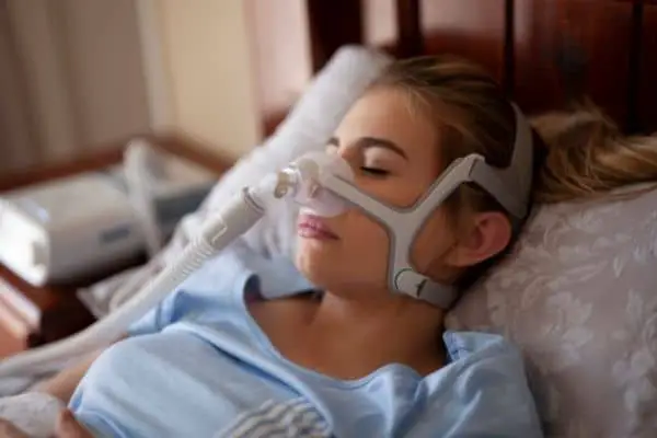 woman wearing cpap machine for obstructive sleep apnea