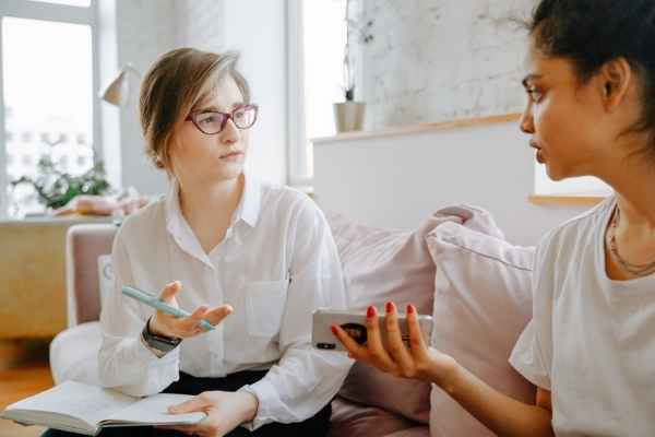 A woman discussing a situation with her friend