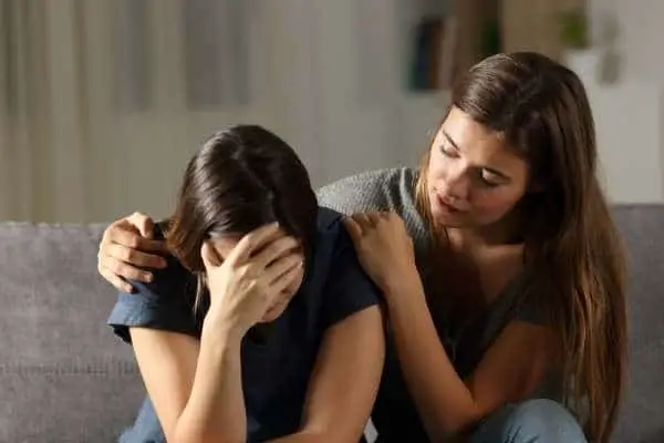Woman with rejection sensitive dysphoria being comforted by her friend