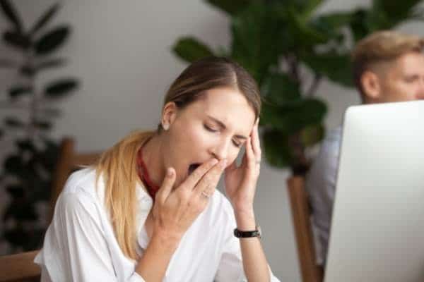 woman yawning at work