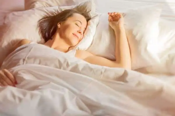 woman smiling and sleeping