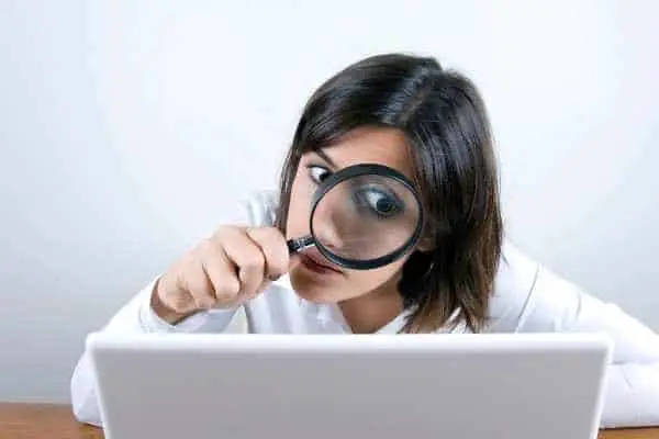 artistic impression of hyperfixation, a woman holding a magnifying glass to focus on a computer screen