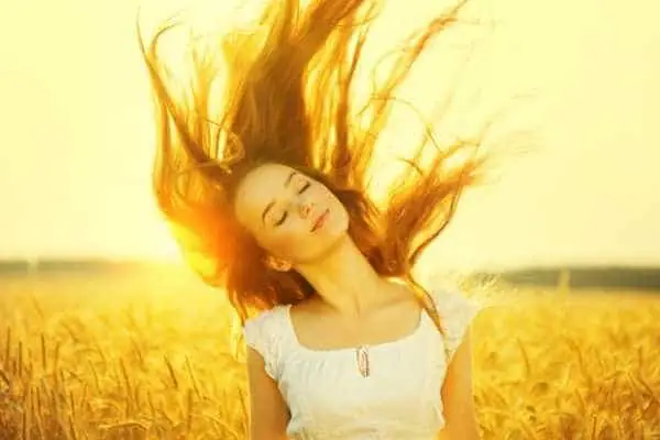 woman in sunny wheat field