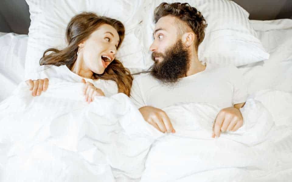 a couple in bed unable to sleep