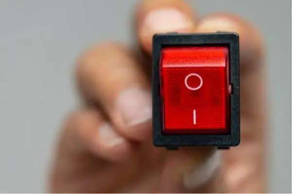 a person holding an on/off switch