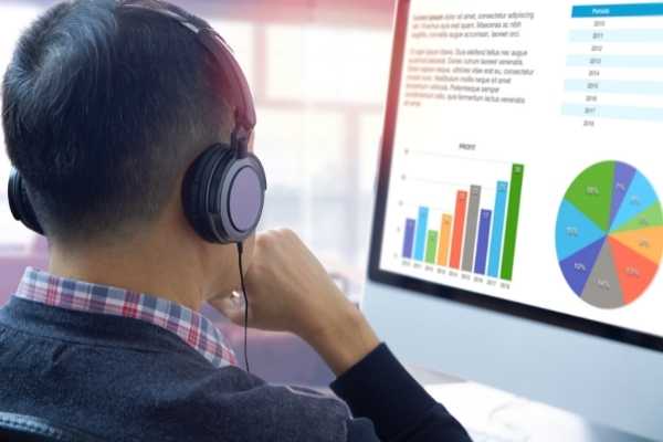 man looking at data presented in graph form on a computer screen