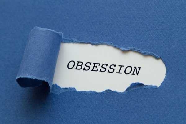 the word obsession revealed by torn paper