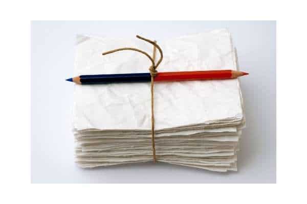 bundle of papers with a pencil ready for writing