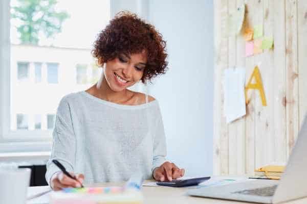 woman smiling and working at her desk