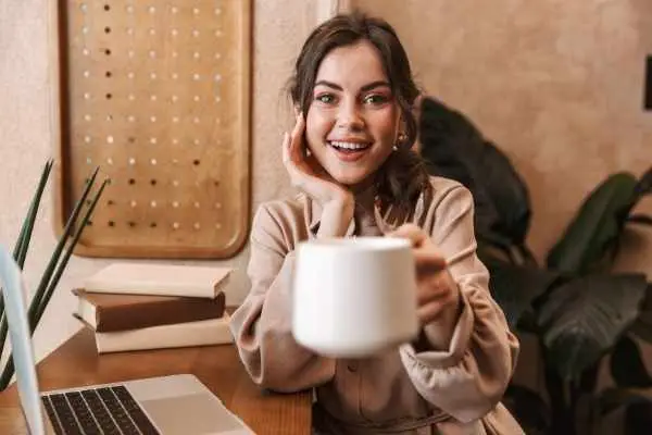 smiling woman with a large cup of coffee