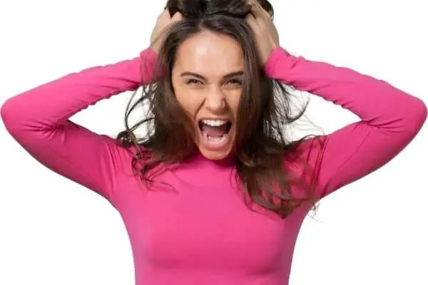 a woman looking straight ahead upset and screaming
