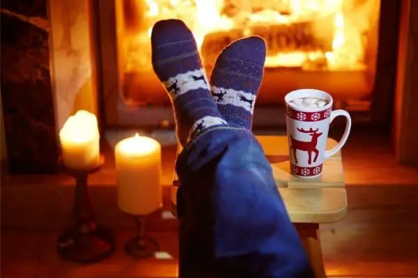 socked feet warming up by a fire