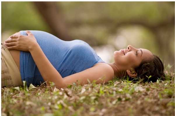 Pregnant woman lying down and looking relaxed