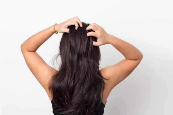 woman scratching the back of her head