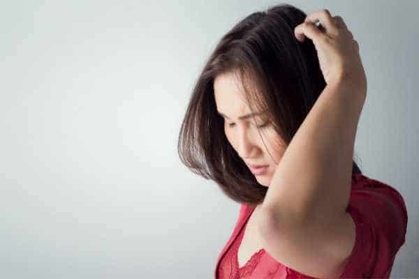 woman scratching the back of her head