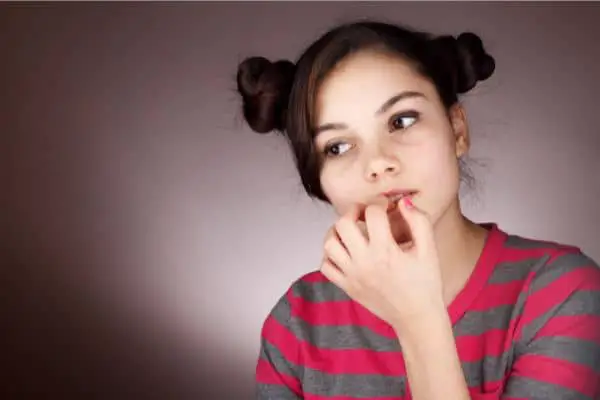 Woman chewing her nails