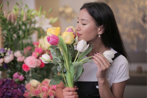 Woman smelling tulips