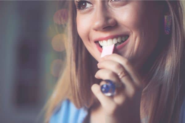 Woman chewing a stick of gum