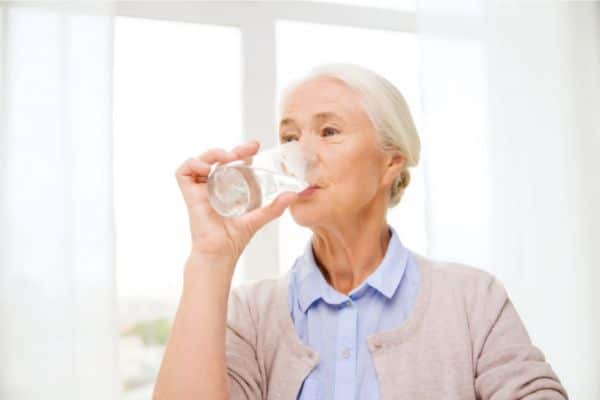 woman drinking a glass of water