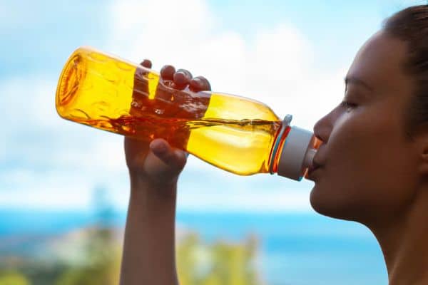 woman drinking from a water bottle