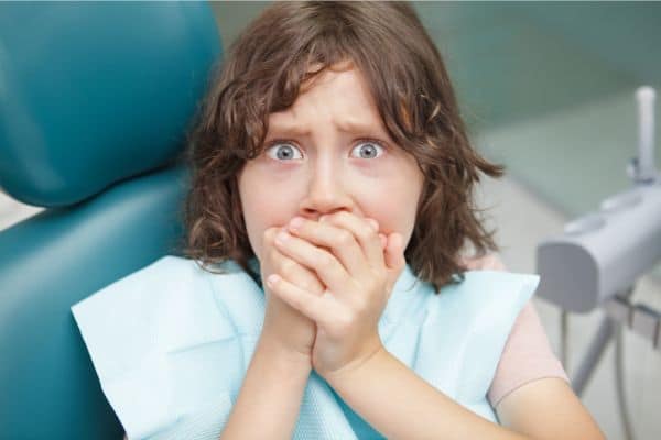 Embarrassed woman in dentist chair