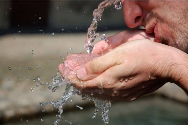 Man drinking from a water fountain
