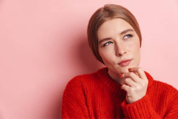 Woman touching chin and thinking